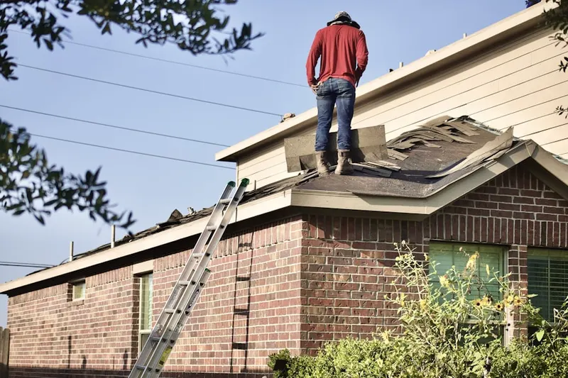 Professional roofer working on a residential roof in Overton Park